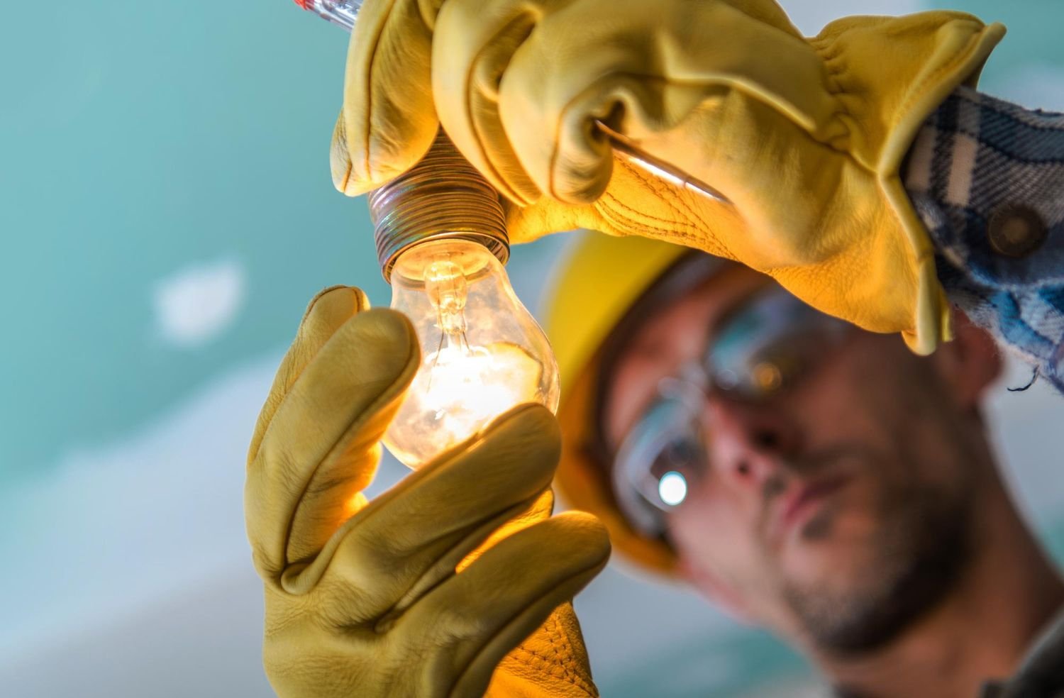 Electrician holding lightbulb
